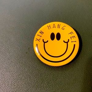 Yellow graphic cartoon smiley face bag pin